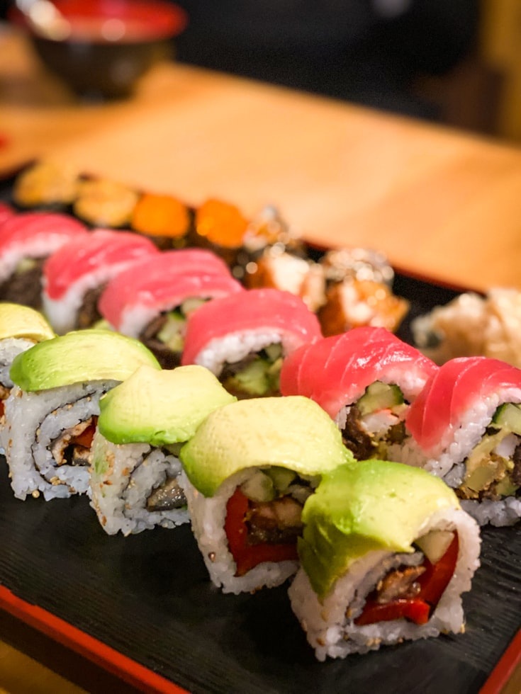 Sushi topped with seafood and avocado